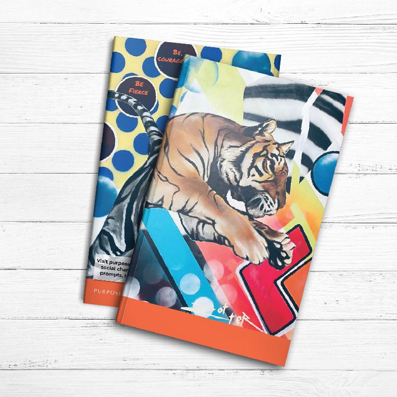 A pair of Fiercely Courageous Journals with a tiger on them.