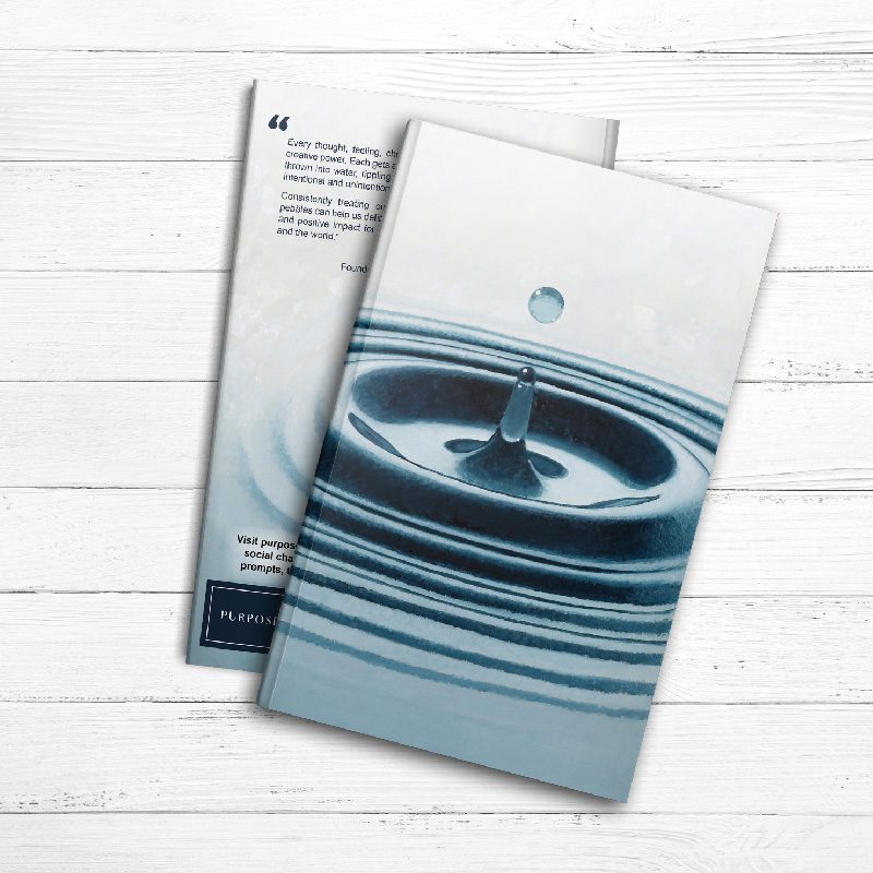 A Ripples of Impact Journal with a water drop on it.